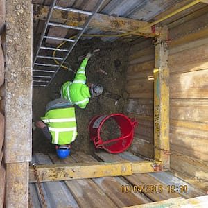 builders in a hole doing plumbing