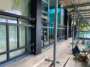 steel bannisters outside a house over lake